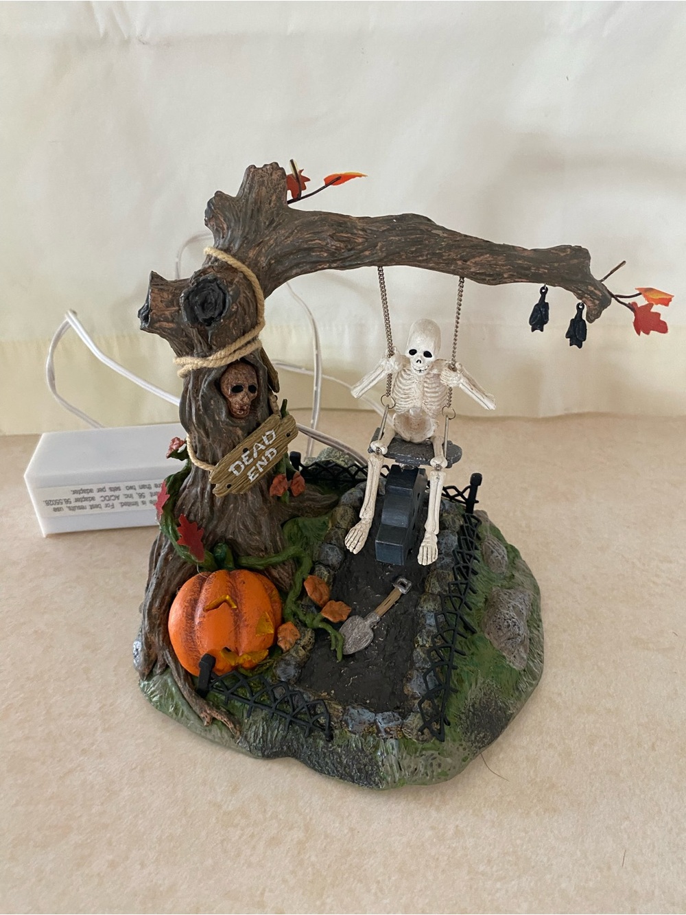Halloween Tree Swing Figurine - Brown & Orange which is battery operated.